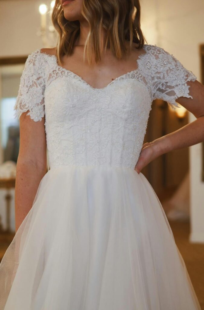 girl wearing a wedding dress with sleeves