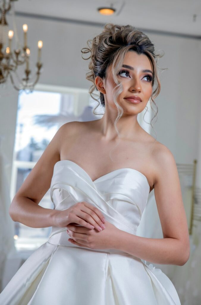teenage girl wearing a white satin quince dress