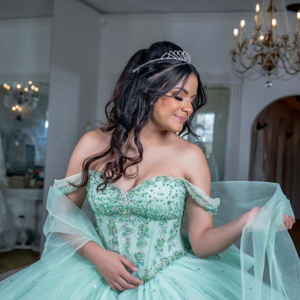 a teal quinceanera dress with a shawl