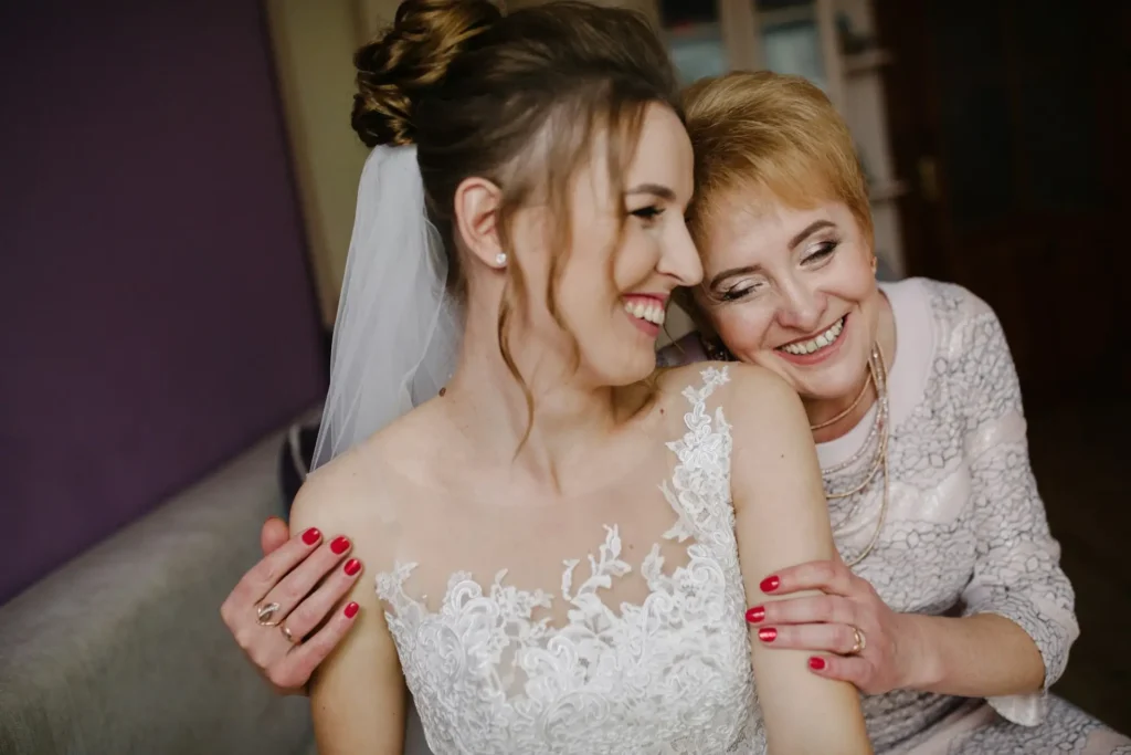 Bride and mother sharing a joyful moment, showcasing simple elegant wedding dresses and inspiration for mother of the bride dresses.